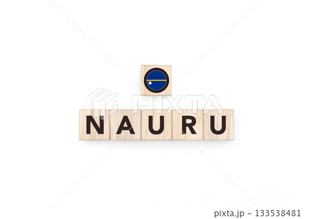 Wooden blocks bearing the name and flag of Nauru. Nauruan and Micronesian Culture, national identity, travel, and geography in a copy space design. 133538481