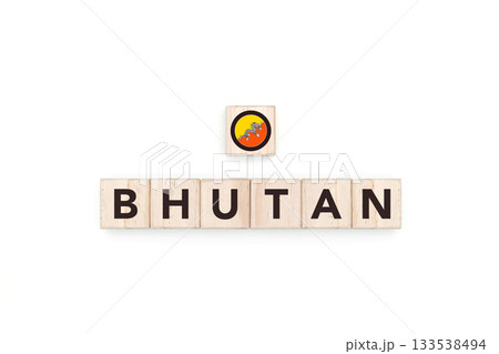 Wooden blocks bearing the name and flag of Bhutan. Bhutanese and Asian Culture, national identity, travel, and geography in a copy space design. 133538494