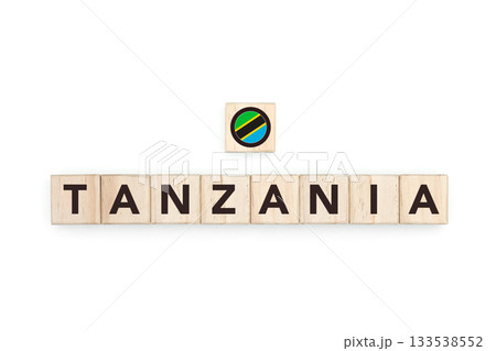 Wooden blocks bearing the name and flag of Tanzania. Tanzanian and South African Culture, national identity, travel, and geography in a copy space design. 133538552