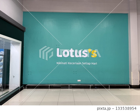 Wall display at Lotus grocery shop with teal background and promotional slogan 133538954