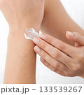 woman applying cream on her hands 133539267