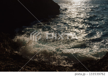 View from a cave to the sea on sunny day in summer. Mediterranean beauty landscape. Waves crashing on a rocky beach 133539762