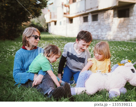 Grandmother Enjoying Outdoor Playtime with Grandchildren 133539811