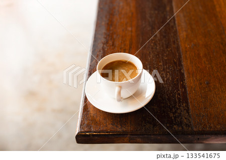 A cup of coffee on wooden table. A cup of coffee on wooden table. 133541675