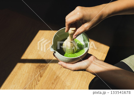 Barista preparing matcha green tea in cafe. 133541678