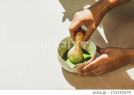 Barista preparing matcha green tea in cafe. 133541679