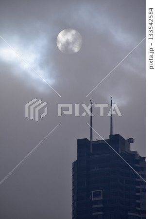 Full moon with dramatic cloudscape. Cloudy overcast sky with moon. Nature scene. 133542584