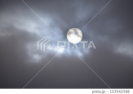 Full moon with dramatic cloudscape. Cloudy overcast sky with moon. Nature scene. 133542586