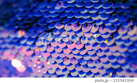 Close-up view of shiny blue sequins reflecting light 133543304