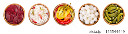 Pickled vegetables in wooden bowls. From left to right beetroot slices, puszta coleslaw, peperoni peppers, pearl onions, and crunchy gherkins, conserved in a vinegar brine with herbs and spices. 133544649