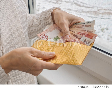 Golden envelope containing with Russian banknotes. Golden envelope containing with Russian banknotes. 133545519