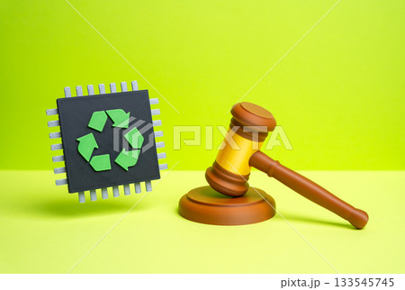 A chip with a recycling symbol and a judge's gavel. Laws and regulations for the recycling of electronic waste and components. ESG policy, tech regulation, and sustainability governance. A chip with a recycling symbol and a judge's gavel. Laws and regulations for the recycling of electronic waste and components. ESG policy, tech regulation, and sustainability governance. 133545745