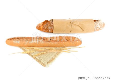 Two Fresh Baguettes Isolated on White: Rustic Wrapped and Traditional Loaf Two Fresh Baguettes Isolated on White: Rustic Wrapped and Traditional Loaf 133547675
