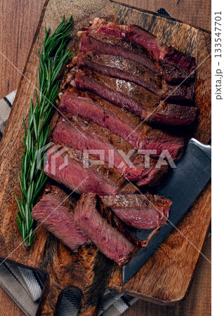 fried steak, beef steak, rib eye steak, sliced steak, on a chopping board, top view, no people fried steak, beef steak, rib eye steak, sliced steak, on a chopping board, top view, no people 133547701