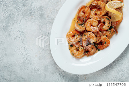 fried tiger prawns, jumbo, in garlic sauce, in butter, with herbs, on a white plate, homemade, no people, 133547706