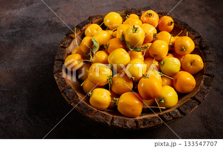yellow small apples, Chinese varieties, in a wooden bowl, top view, no people, 133547707