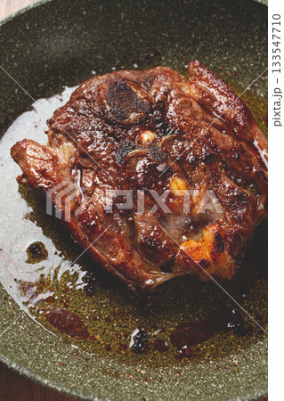 fried steak, veal neck on the bone, cooking meat in a frying pan, top view, no people, 133547710