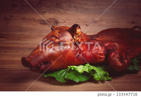 Baked, fried piglet, on a wooden table, no people, Baked, fried piglet, on a wooden table, no people, 133547716