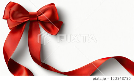 A vibrant red bow with a silky ribbon lies against a clean white backdrop, perfect for adding charm to gifts and decorations 133548750