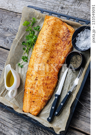 roasted whole salmon fillet on baking sheet 133549091