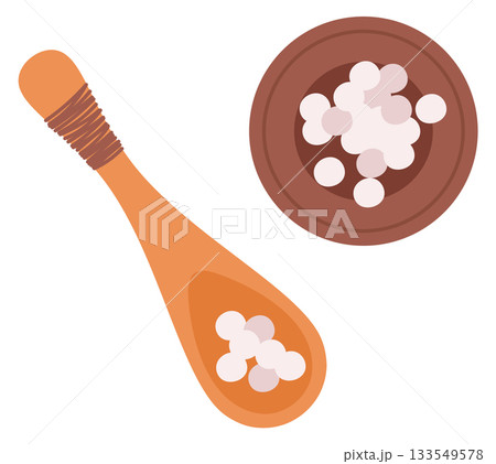 A spoon and a bowl of small white balls 133549578