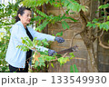 An old woman is happily gardening 133549930