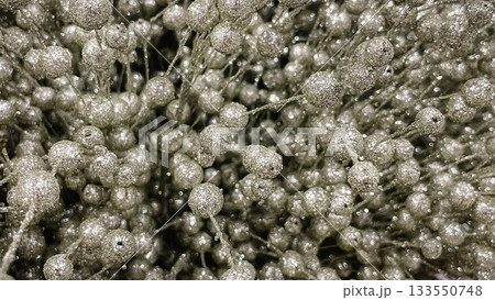 Abstract background of glittering gold metallic leaves and berries texture for a festive holiday design Abstract background of glittering gold metallic leaves and berries texture for a festive holiday design 133550748