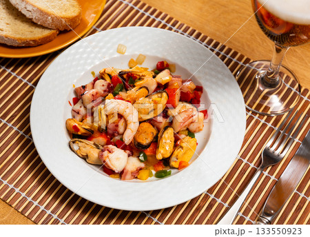 Salad of Spanish cuisine is Seafood Salpicon, made from chopped seafood and vegetables in dressing or sauce 133550923