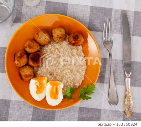 Meatballs with scrambled eggs and oatmeal - healthy lunch Meatballs with scrambled eggs and oatmeal - healthy lunch 133550924