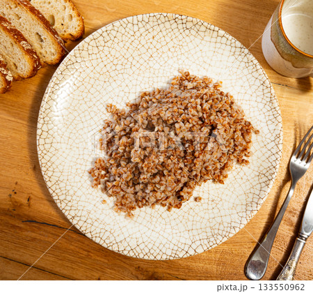 Buckwheat porridge served on plate 133550962