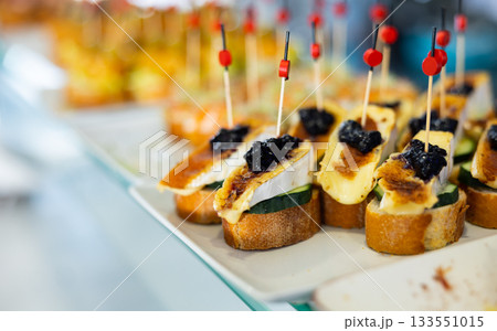 Spanish tapas - pinchas with goat cheese, cucumber and white bread Spanish tapas - pinchas with goat cheese, cucumber and white bread 133551015