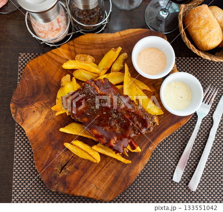 Grilled pork ribs rack with barbecue sauce with potatoes Grilled pork ribs rack with barbecue sauce with potatoes 133551042