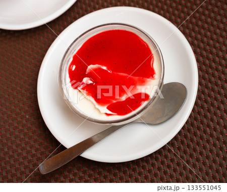 Creamy panna cotta with cranberry jam in glass bowl Creamy panna cotta with cranberry jam in glass bowl 133551045