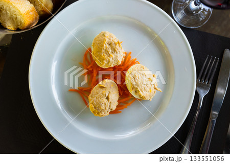 Several boiled chicken eggs with meat filling are laid out on plate. Several boiled chicken eggs with meat filling are laid out on plate. 133551056