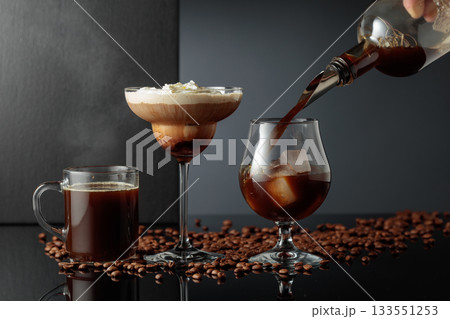 Black coffee and iced coffee cocktails on a black reflective background. 133551253