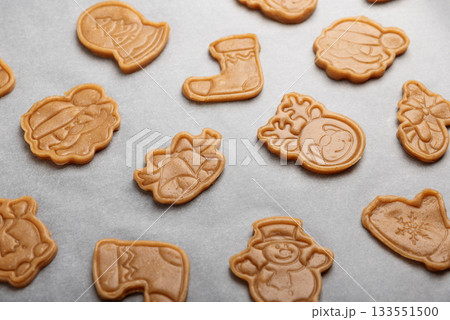 Unbaked Christmas Holiday Cookies with Festive Shapes on Baking Tray Unbaked Christmas Holiday Cookies with Festive Shapes on Baking Tray 133551500