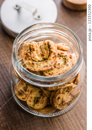 Crunchy salted crackers in jar on wooden table. Crunchy salted crackers in jar on wooden table. 133552300
