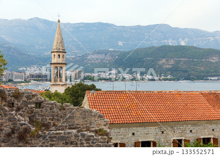 Church of St. John the Baptist and distant boats on the bay of Budva, Montenegro 133552571
