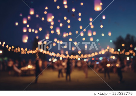 Blurred people releasing lanterns at night, glowing lights floating in sky, festive outdoor celebration, dreamy atmosphere, warm evening, joyful gathering 133552779