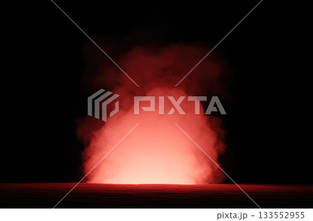 Defocused lava fountain at night with surreal glowing red smoke, dramatic volcanic eruption, intense heat, and mysterious atmosphere in dark landscape Defocused lava fountain at night with surreal glowing red smoke, dramatic volcanic eruption, intense heat, and mysterious atmosphere in dark landscape 133552955