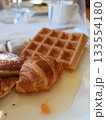 Golden Croissant, Waffle, And Pancake Breakfast Platter For Cozy Morning Brunch Setting 133554180