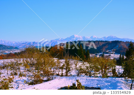 紅葉の越後里山・冠雪の越後三山風景 133554929