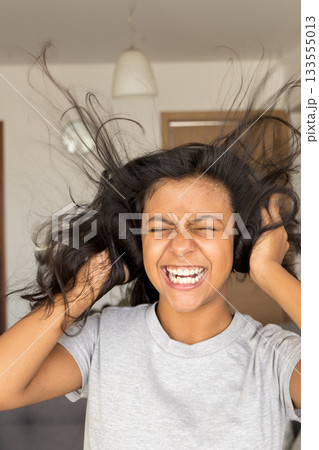 Cute teenager listening to music with her earphones Cute teenager listening to music with her earphones 133555013