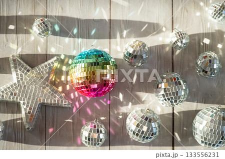 Rainbow disco ball and silver disco balls with light reflections. 133556231