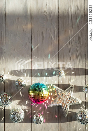 Disco balls and mirrored star on rustic wooden background 133556232