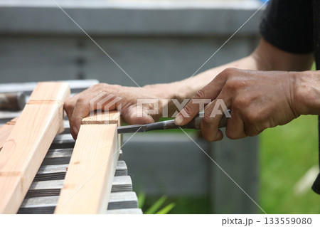 ノミで材木を削る男性 ノミで材木を削る男性 133559080