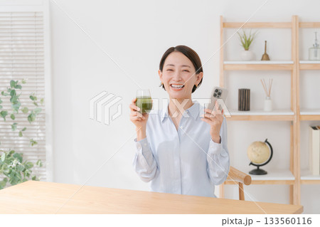 青汁とスマホを持つ女性 青汁とスマホを持つ女性 133560116
