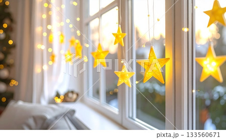 Bright Yellow Star and Yellow Christmas Lights Hanging on Window Edge Bright Yellow Star and Yellow Christmas Lights Hanging on Window Edge 133560671