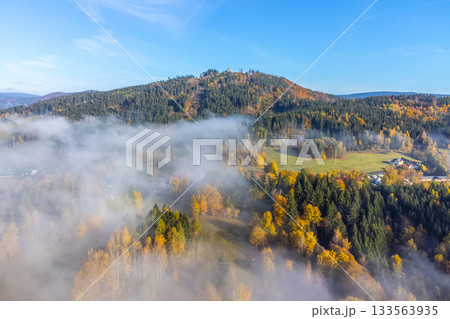 Colorful autumn landscape with Tanvaldsky Spicak Mountain in Jizera Mountains, Czech Republic Colorful autumn landscape with Tanvaldsky Spicak Mountain in Jizera Mountains, Czech Republic 133563935