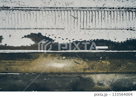 Aerial view of an abandoned wooden ship at the bottom of the river in winter, against the background of white snow and black water Aerial view of an abandoned wooden ship at the bottom of the river in winter, against the background of white snow and black water 133564004